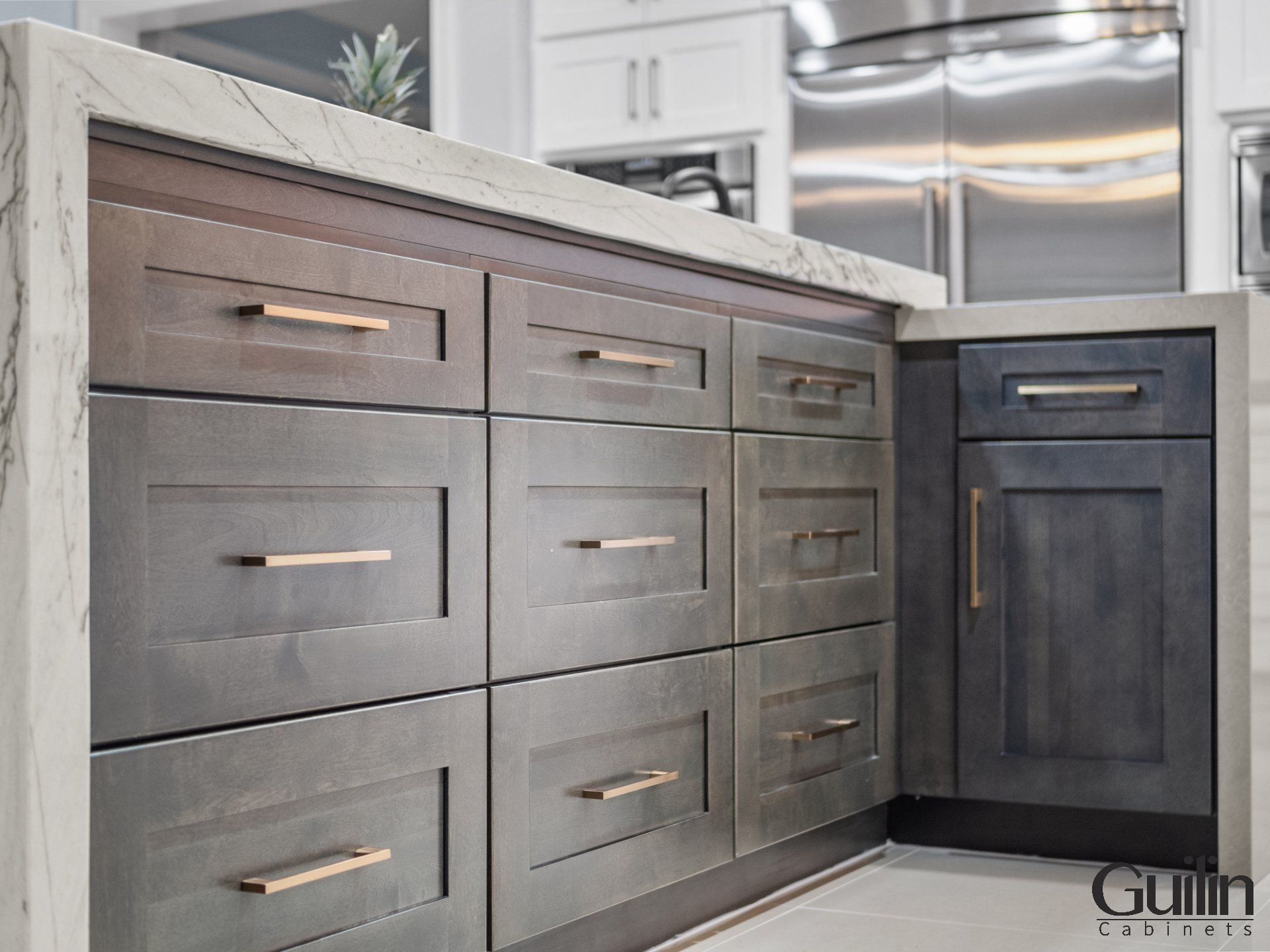 Kitchen cabinets are typically larger and higher than bathroom cabinets and are designed to store heavier kitchen items such as dishes, utensils, and food.