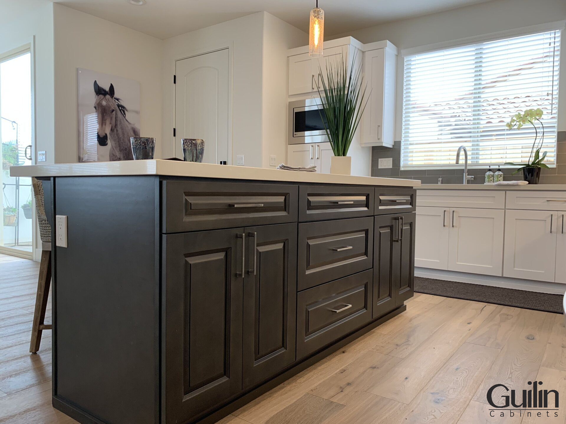 An island adds extra kitchen counter space to an L-shaped kitchen