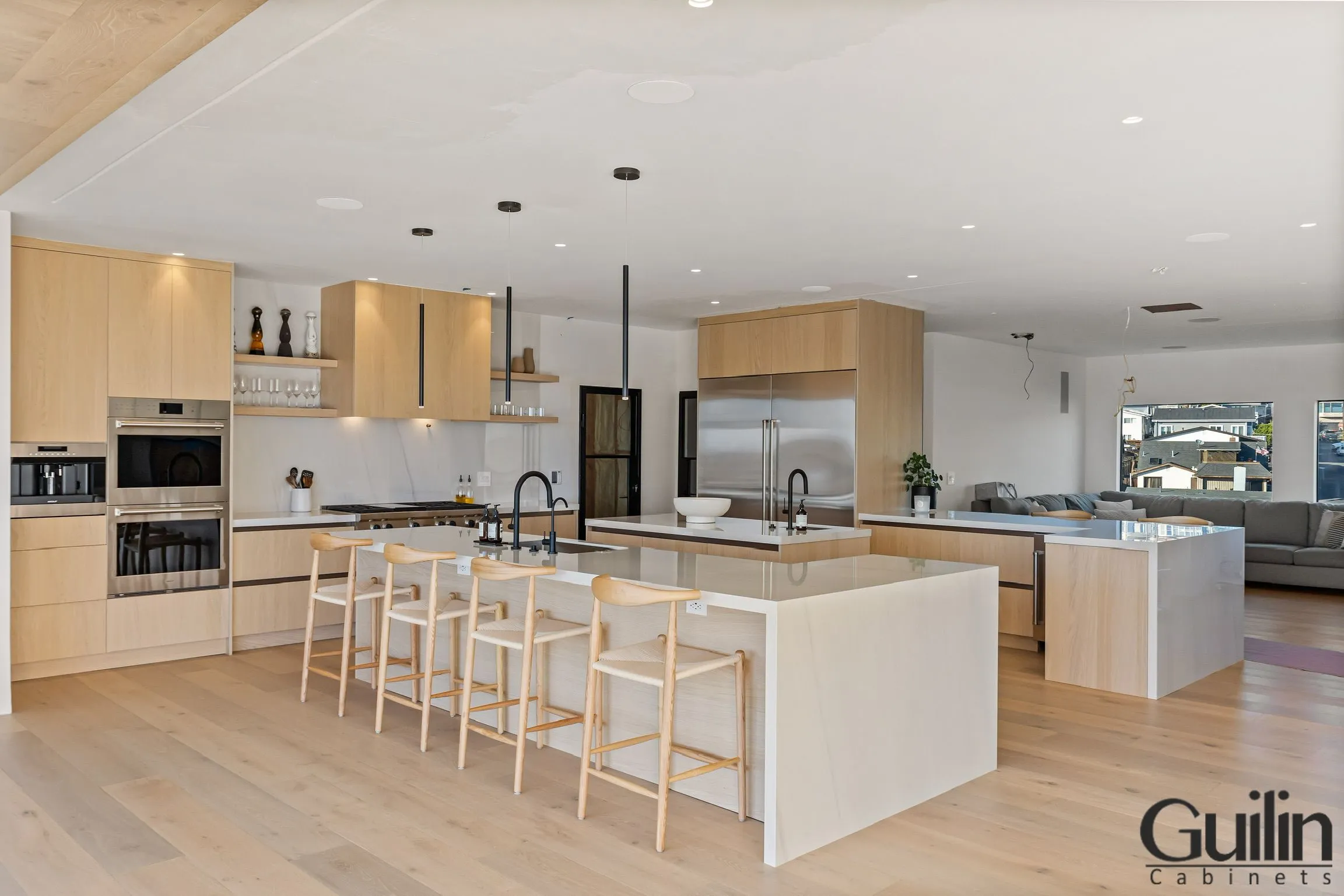 In this particular kitchen design, the "G" shape is formed by a lengthy, uninterrupted counter that encircles all three walls of the cooking space.