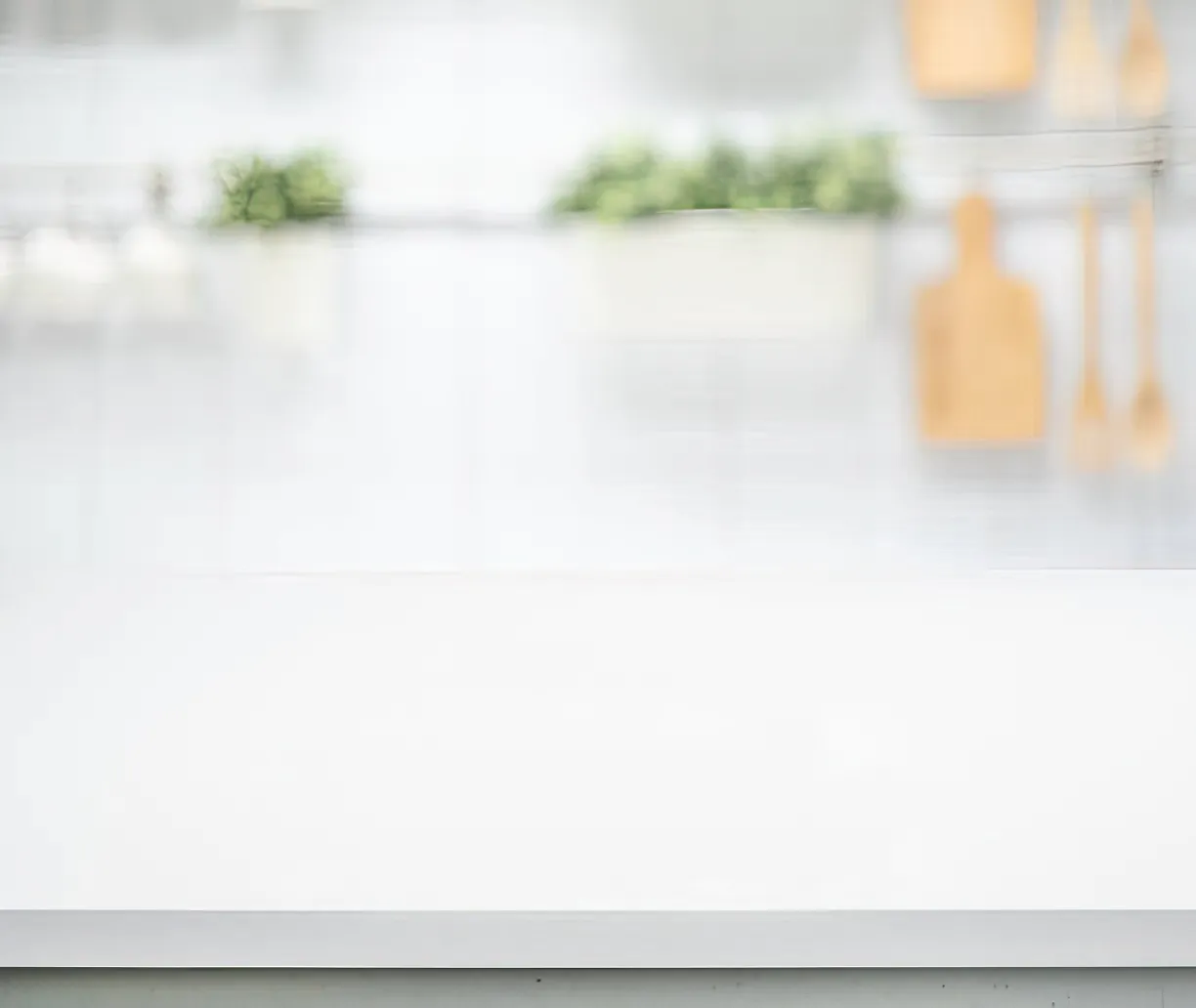 Sanding the surface of the countertops painting to help the paint adhere better.