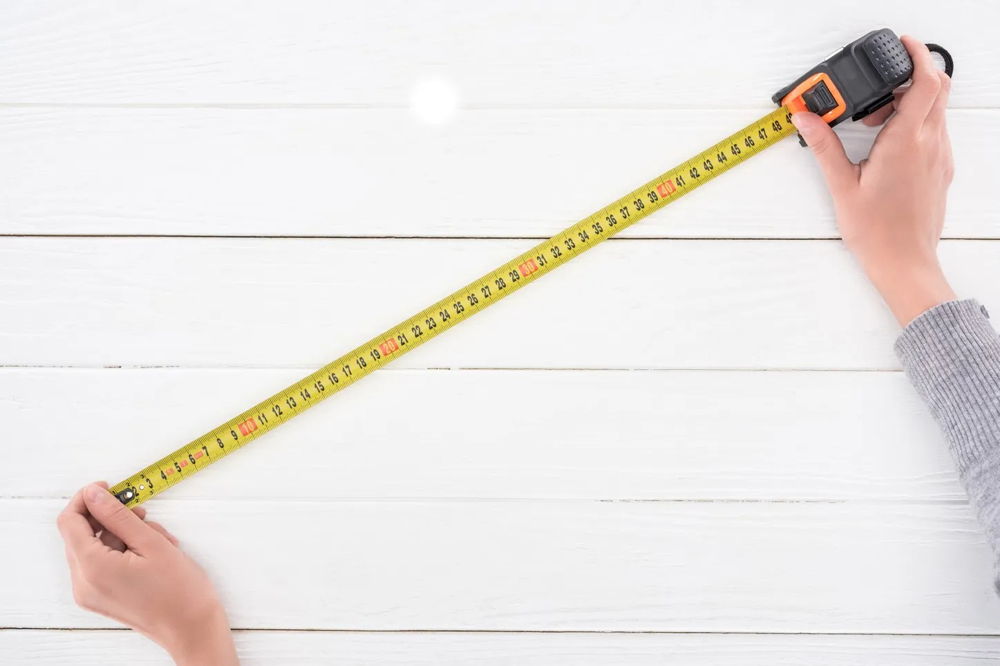 A measuring tape is a versatile tool that helps you measure the length, width, and height of the space where you want to install your cabinets.