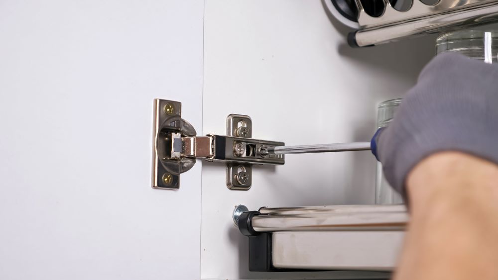 The first step in changing cabinets without removing countertops is to take the old cabinets apart, being sure to remove the doors and drawers.